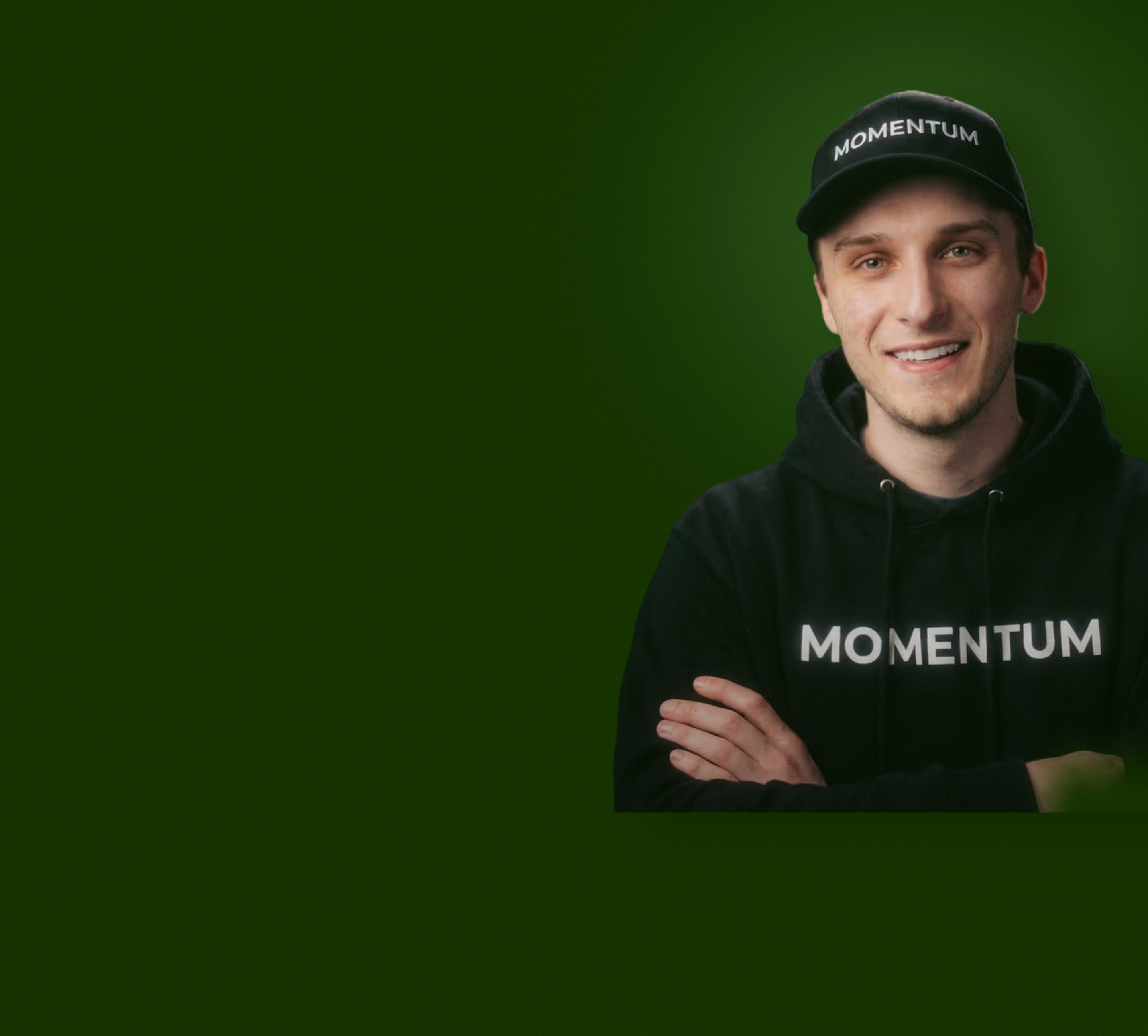 Kevin Cabana, founder and lead trader of Momentum, arms crossed, in a Momentum cap and hoodie